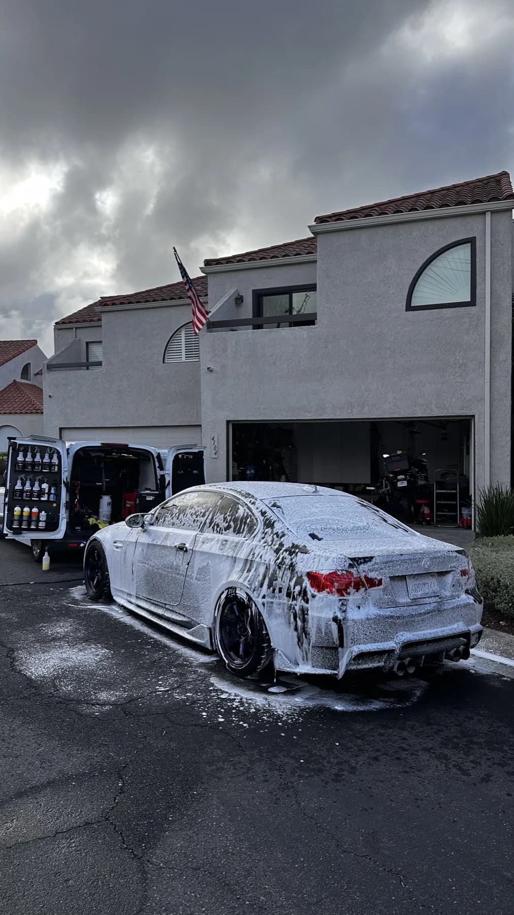 Sedan covered in foam during a mobile detail